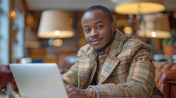 Man Sitting at Table Using Laptop Computer photo