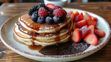 Stack of Pancakes Topped With Berries and Syrup photo