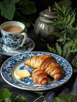 Blue and White Plate With Croissant and Cup of Coffee photo