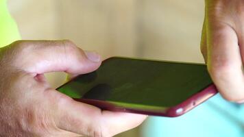 Man sea smartphone. The young man in sunglasses, sunbathing by the sea and spending time on his mobile phone texting with girlfriend, looks at the camera in surprise, sees a news on the phone. video