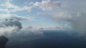 Aerial view. The drone flies over foggy and fluffy clouds. Blue sky sun and sea fog. Abstract aerial nature summer ocean sunset sea and sky background. Horizon. Vacation, travel and holiday concept video