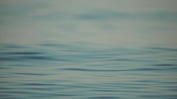 Sea water surface. Camera flies over the calm azure sea. Nobody. Holiday recreation concept. Abstract nautical summer ocean nature. Weather and climate change. Slow motion. Close up video
