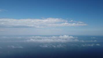 Aerial view. Blue sky sun and fog over calm sea. The drone flies over foggy and fluffy clouds. Abstract aerial nature summer ocean sunset sea and sky background. Vacation, travel and holiday concept. video