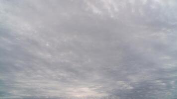 Timelapse gray rainy clouds float across the dark sky on a cloudy day. Black Stratocumulus clouds moving fast in dramatic sky on sunset. video