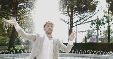 Happy Young Man Dancing in Water Fountain in Summer Time video