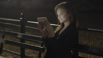 Young Woman Using Tablet Computer In The Park At Night video
