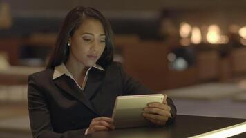Young Attractive Businesswoman Using Tablet Computer Inside Bar Lobby video