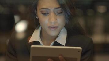 Confident Woman Browsing the Web Internet on Mobile Tablet Device video