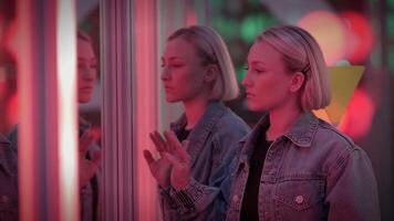 Young Blond Woman Exploring Room of Mirrors in Dreamlike Fantasy Neon Light video