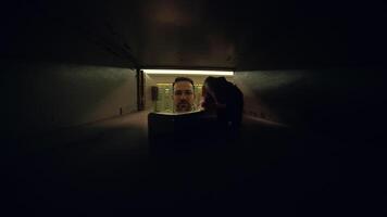 A man is retrieving mail from a safe deposit box inside a secure vault at a bank video