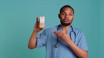 Portrait of doctor talking about importance of using high protection sunscreen products, studio backdrop. African american healthcare specialist telling people to use anti ultraviolet creams, camera A video