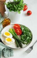 Fresh Spring Salad With Boiled Eggs, Asparagus, and Tomatoes on a Bright Day photo