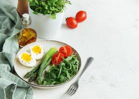 Fresh Spring Salad With Boiled Eggs, Asparagus, and Tomatoes on a Bright Day photo