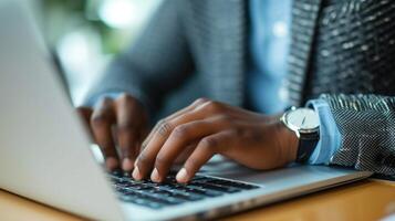 A closeup of a workers hands typing on their laptop showcasing their newfound digital skills from a literacy program photo