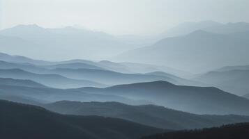 In the distance the mountains are ly visible through the mist giving a sense of depth and vastness to the landscape photo