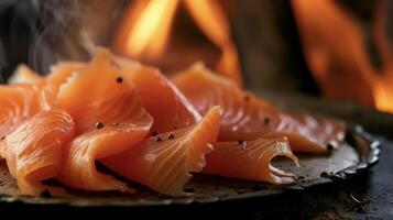 Thin slices of smoked salmon glistening under the warm glow of the fire adding a touch of elegance to any seafood dish photo