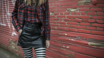 Get creative with your punk style by mixing and matching different patterns and textures. A plaid shirt paired with a leather skirt and bold striped tights creates a oneofakin photo