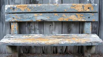 Texture of a wooden bench the once smooth surface now shows signs of aging with cracks gouges and a grayish hue from years of rain and sun photo