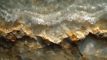 Texture of a riverbed the gentle flow of water creating unique patterns in the san photo