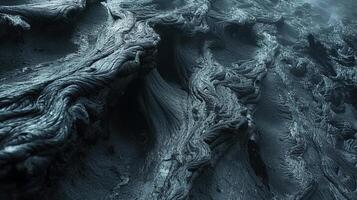 Closeup of lava formations shaped by strong currents creating a mesmerizing rippled and layered texture photo