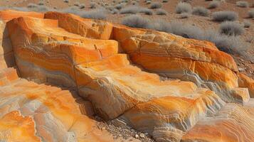The texture of red sand shows a rugged landscape with deep crevices and layers forming a visual timeline of erosion and weathering over the years photo