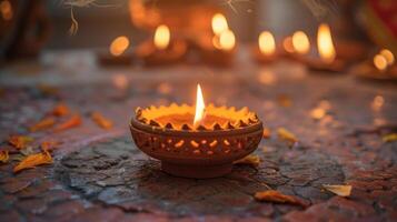 A closeup of a traditional clay diya lamp with a flickering flame symbolizing the victory of light over darkness during Diwali photo