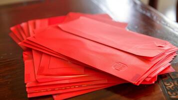 Red envelopes or hong bao filled with crisp bills are p on the table ready to be gifted to children and single individuals a symbol of good luck and fortune for the new year photo