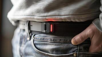 A sensor attached to a belt or waistband tracking posture and sending notifications for correcting slouching or sitting for too long photo