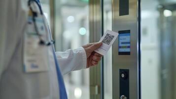 A medical professionals hand using a card with a QR code to quickly access a patients records on the system photo