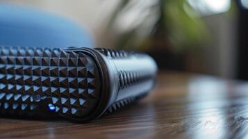 A closeup of a smart foam roller with pressure sensors and a smartphone app for personalized myofascial release and pain management for individuals with chronic back pain photo