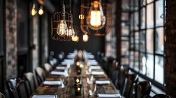 A row of hanging caged light bulbs dangles above a long wooden table in a factoryturnedrestaurant giving off a vintage vibe photo