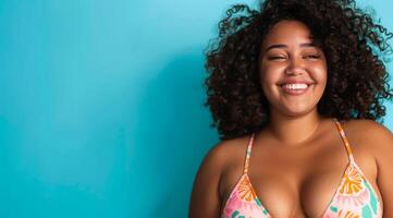 A plus size black afro-american bikini model with curly hair is smiling and wearing a bikini top photo