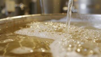 Tiny bubbles form on the surface of a tank during the secondary fermentation process where yeast converts sugar into alcohol in sparkling wine photo