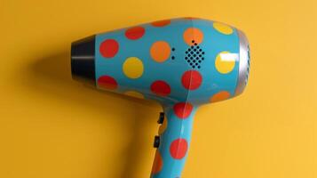 A travelsized hair dryer with a colorful polka dot pattern and a dual voltage switch for international use photo