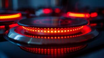 The red hot surface indicator light glowing on an induction cooktop warning of residual heat photo