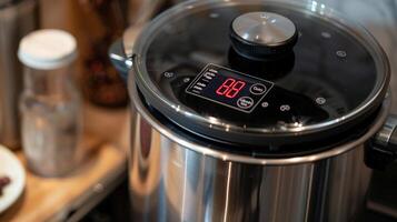 The LED display showing the precise temperature and cooking time of the sous vide cookers water bath photo