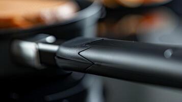 Closeup of the handle on a sandwich maker featuring a heatresistant grip for easy and safe handling photo