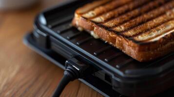 Closeup of the power cord on a sandwich maker showing its length and how it can easily be stored away when not in use photo