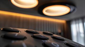 A detailed shot of the ceiling fans remote control with buttons for speed rotation and light photo