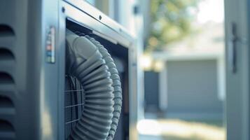 A closeup of the exhaust hose on a portable air conditioner used to direct hot air outside through a window or vent photo