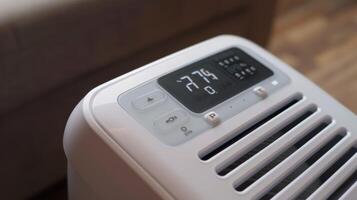 A closeup of the remote control for a portable air conditioner with clearly labeled buttons and a compact design for convenience photo