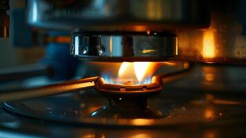 A macro view of the pilot light on a water heater emitting a small steady flame photo