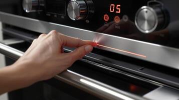 A timer button being pushed on a convection oven with a bright red display counting down the cooking time photo