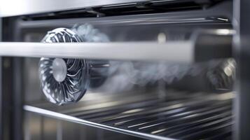 A closeup of the convection fan in action spinning and circulating hot air for fast and efficient cooking photo