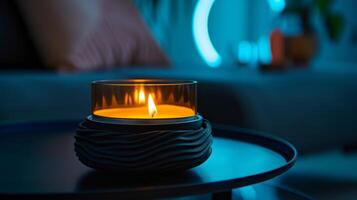A simple yet chic candle warmer in matte black with a textured surface and a glass dish for melting wax perfect for a modern and minimalist decor photo