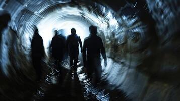 A group of shadowy figures are shown walking through a narrow winding tunnel their faces obscured and their purpose unknown photo