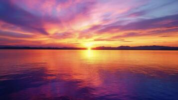 A colorful array of hues paints the sky as the sun sets over the lake creating a breathtaking and peaceful sight photo