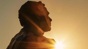A wellknown statue of a historical leader illuminated by the setting sun photo