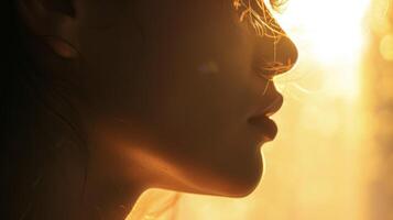 The backlighting creates a soft ethereal quality around the profile of a persons face photo