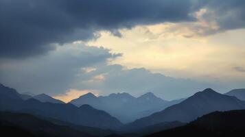 The fading light creating a dramatic contrast between the mountains and the sky photo